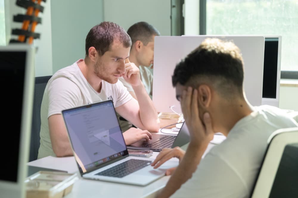Builders pairing at a desk
